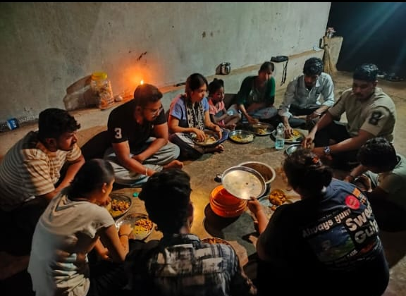 Camp participants and community members gathered in a circle sharing a traditional communal dinner at the Ethno Cultural Camp